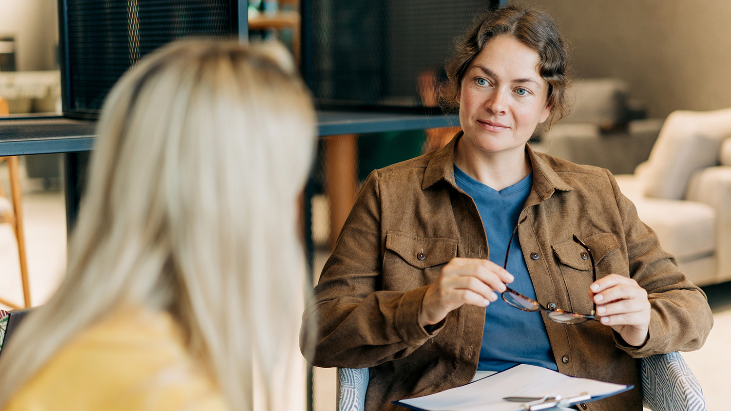 A female psychologist consults a client while sitting in the off